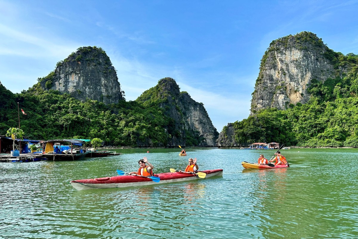 Chèo kayak qua Làng Chài Vùng Viêng, bao quanh bởi các dãy núi đá vôi.