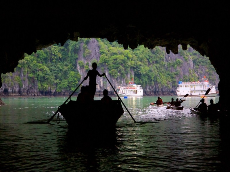 Một chuyến đi thuyền tre thơ mộng qua Hang Luồn, mang đến hành trình yên bình qua cảnh quan xanh tươi và làn nước tĩnh lặng.