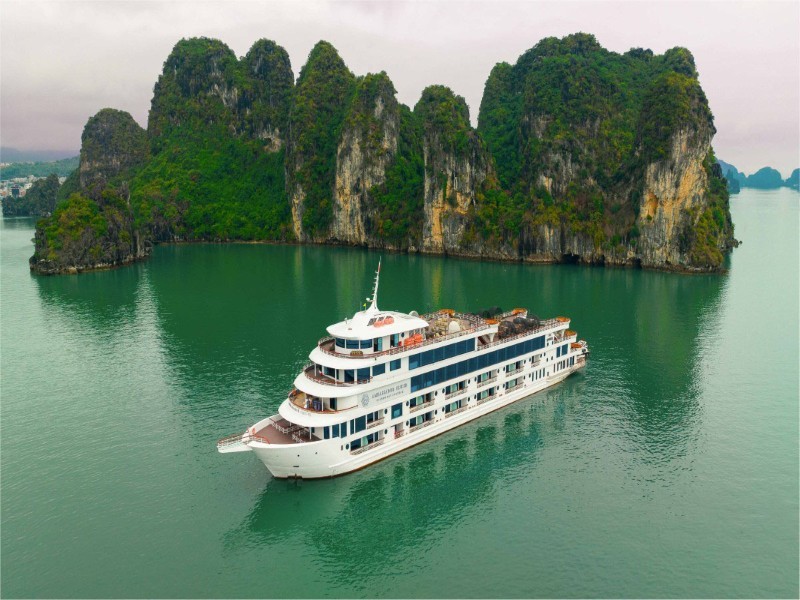 Ambassador Cruise against the breathtaking limestone backdrop of Halong Bay.